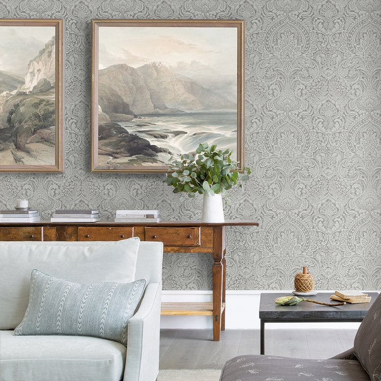 a living room with two paintings on the wall